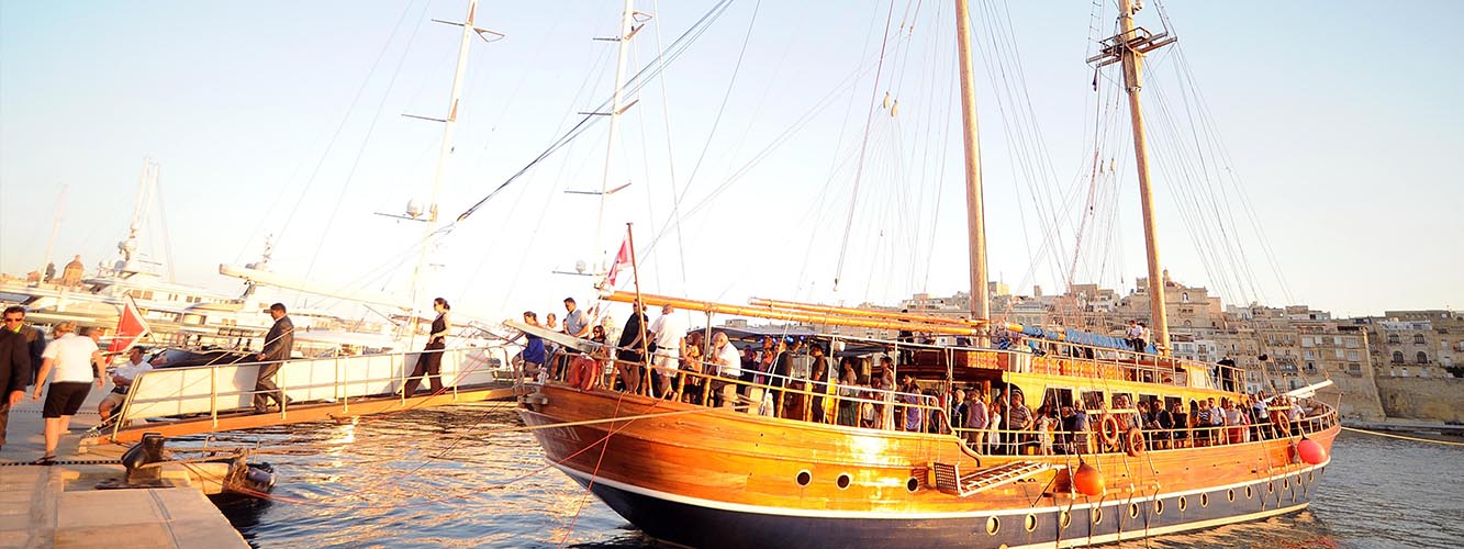 sunset event seaside harbour wooden boat music fun malta gozo